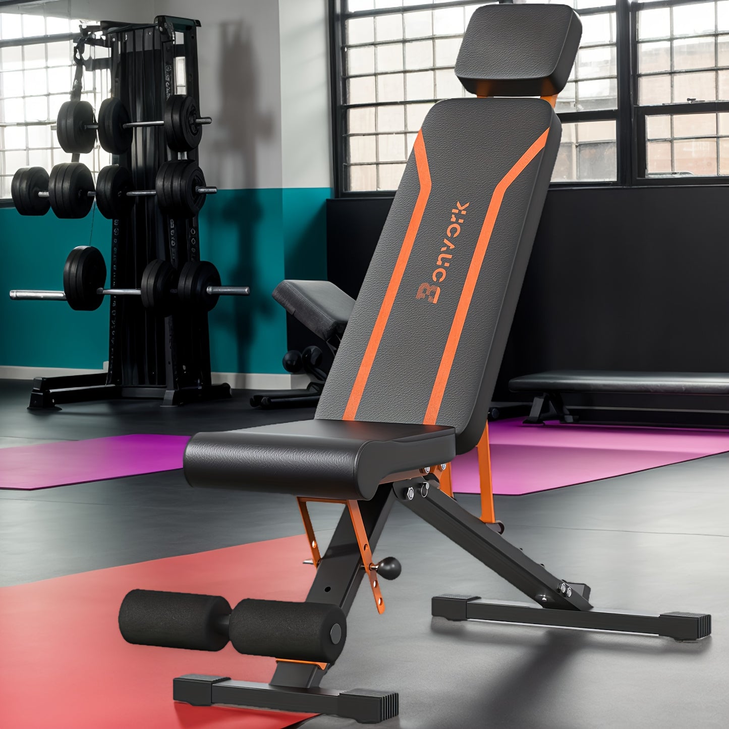 Black and orange adjustable weight bench in a gym setting with weights and exercise equipment.