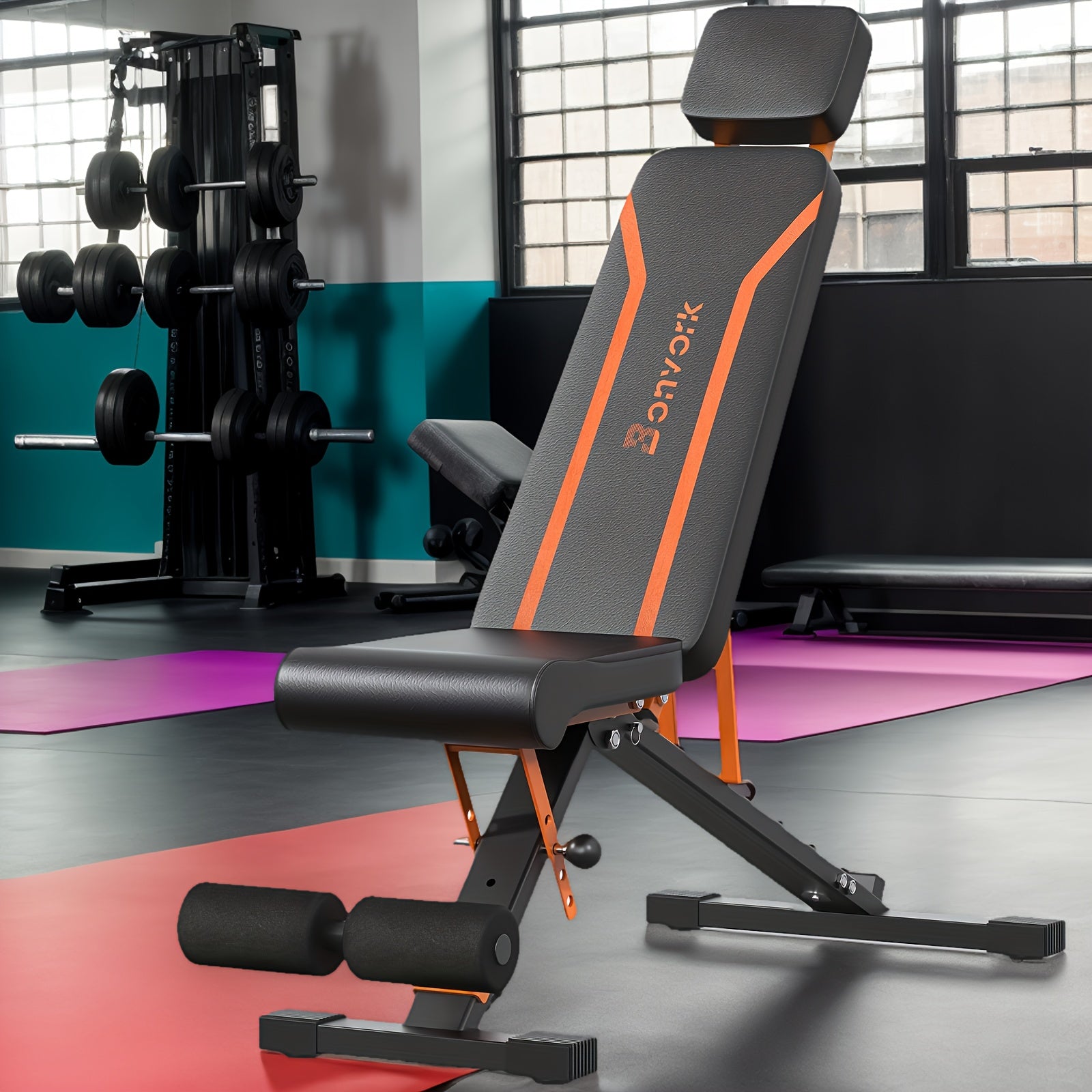 Black and orange adjustable weight bench in a gym setting with weights and exercise equipment.