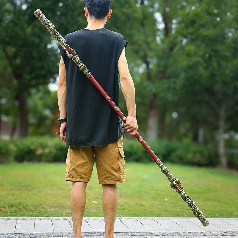 Person holding a Sun Wukong Stick  in a park setting