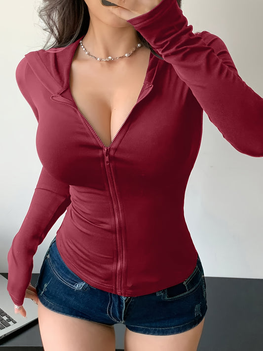 Person wearing a red zip-up top and denim shorts against a neutral background