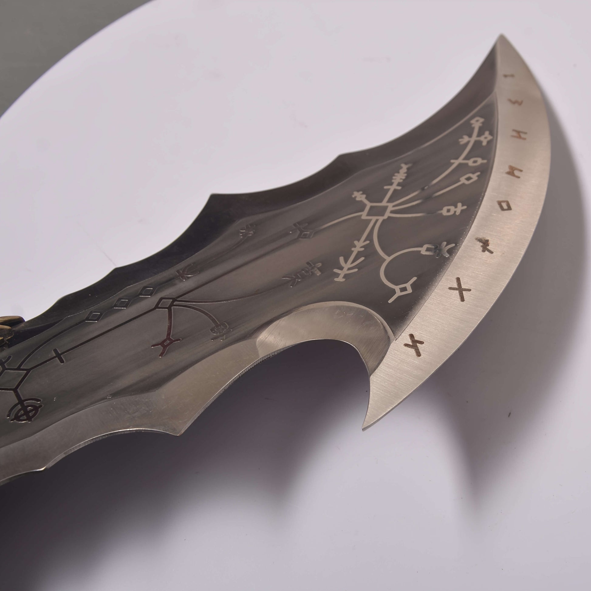 Chaos blade with engraved patterns on a white background