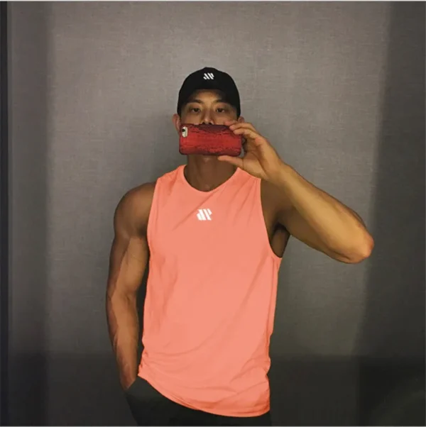 A baby pink mens tank top sold by 100 Spartans