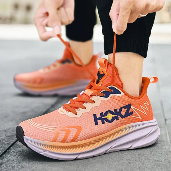 A man wearing an orange Apex Stride 2023 Running Shoes sold by 100 Spartans