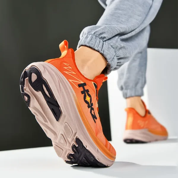 A man wearing an orange Apex Stride 2023 Running Shoes sold by 100 Spartans