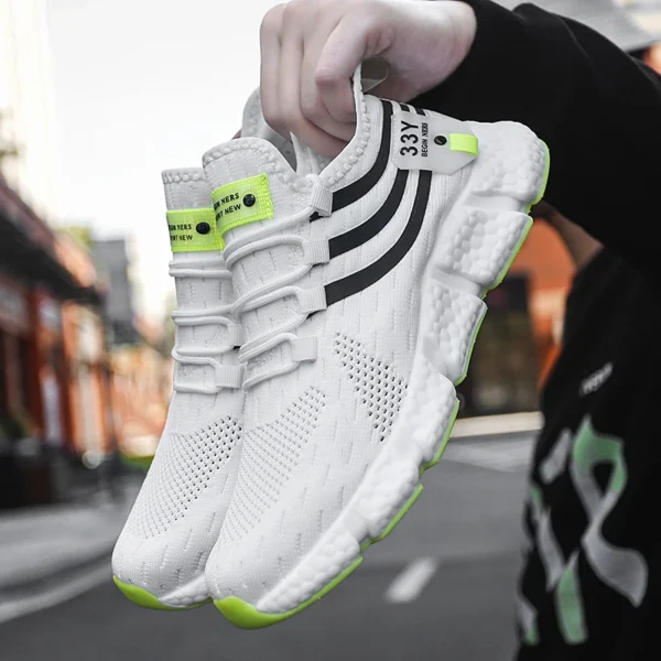 A person holding a white velocity Pro Running Sneakers sold by 100 Spartans