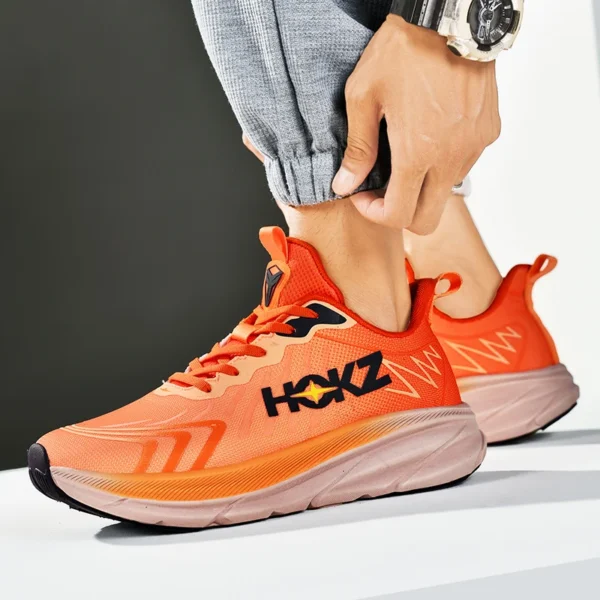 A man wearing an orange Apex Stride 2023 Running Shoes sold by 100 Spartans