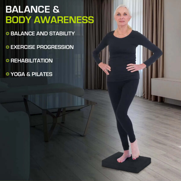 A women standing on a black balance pad sold by 100 Spartans