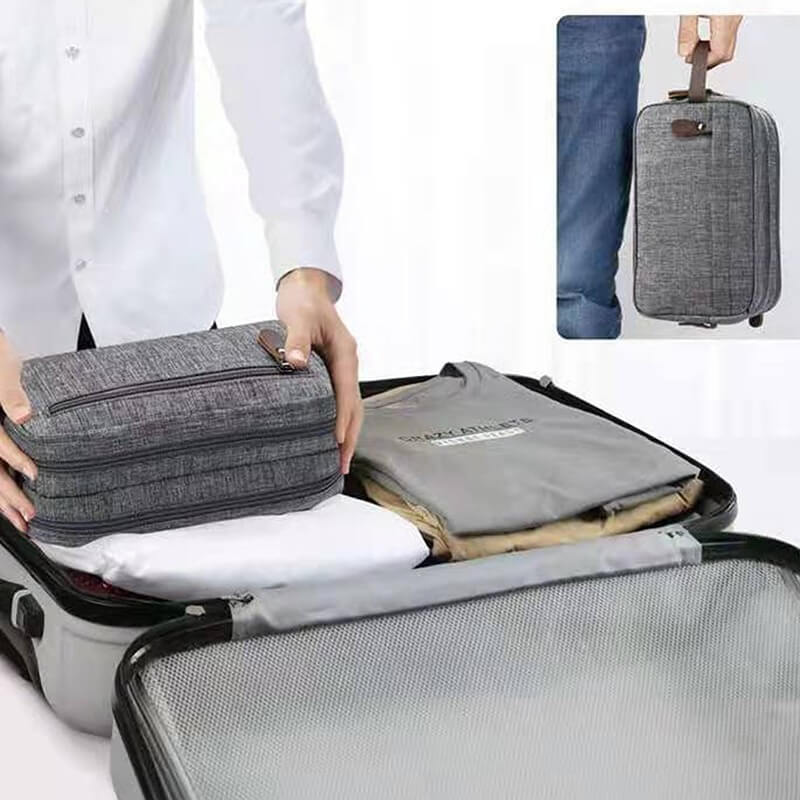 A grey toiletry bag for men packed in a luggage bag sold by 100 Spartans