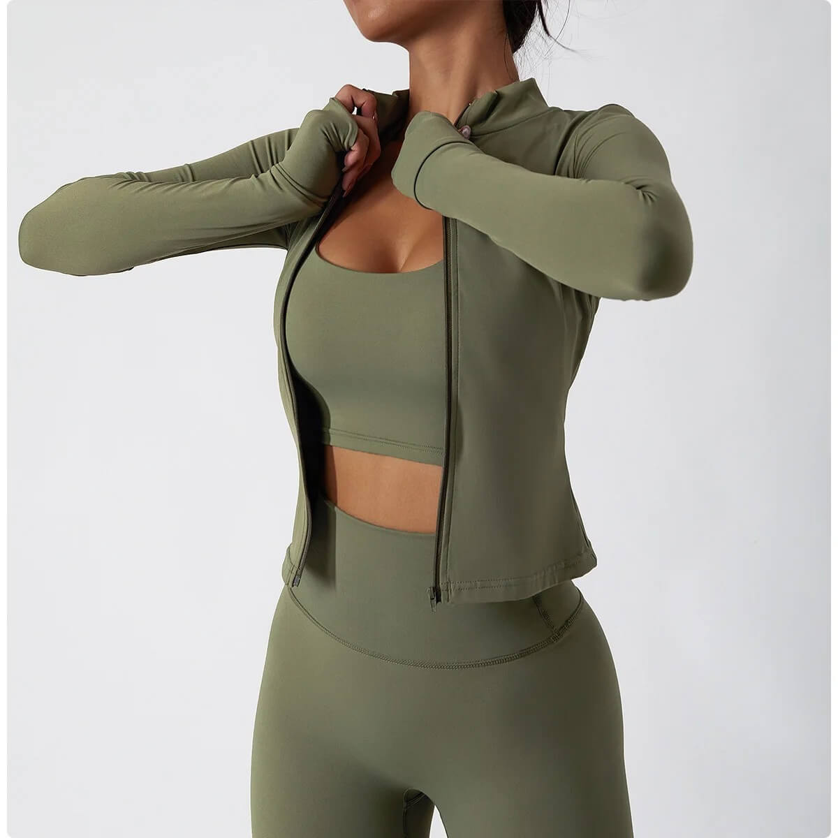 The woman wearing a green 3 piece womens tracksuit sold by 100 spartans