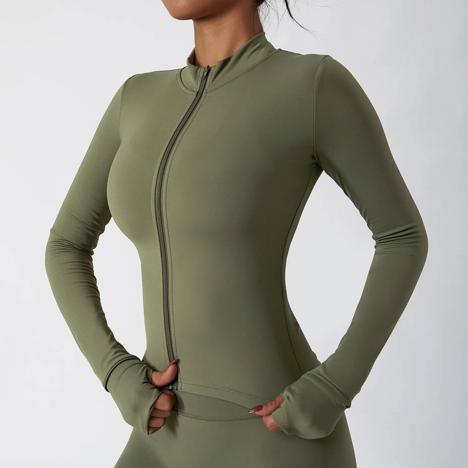 The woman wearing a green 3 piece womens tracksuit sold by 100 spartans