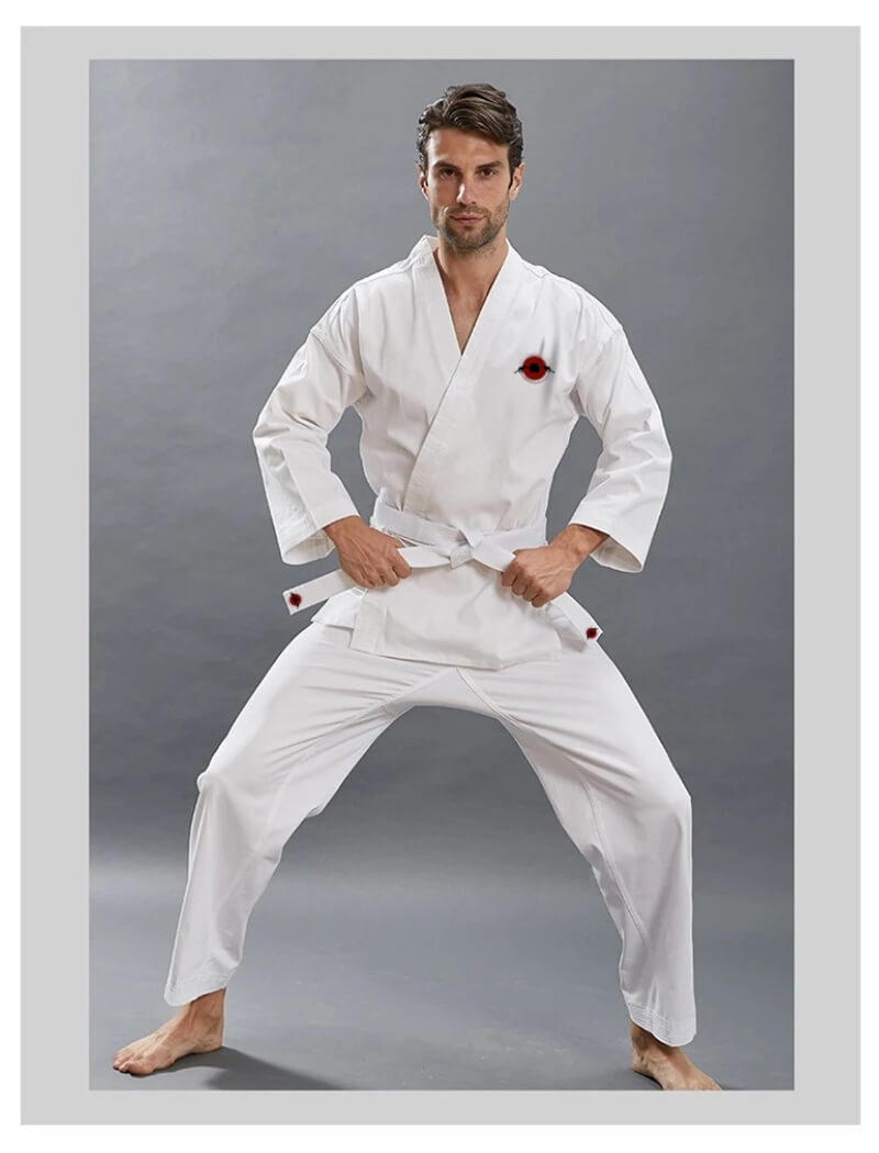 A man wearing a14oz heavy karate gi and white karate belt sold by 100 Spartans