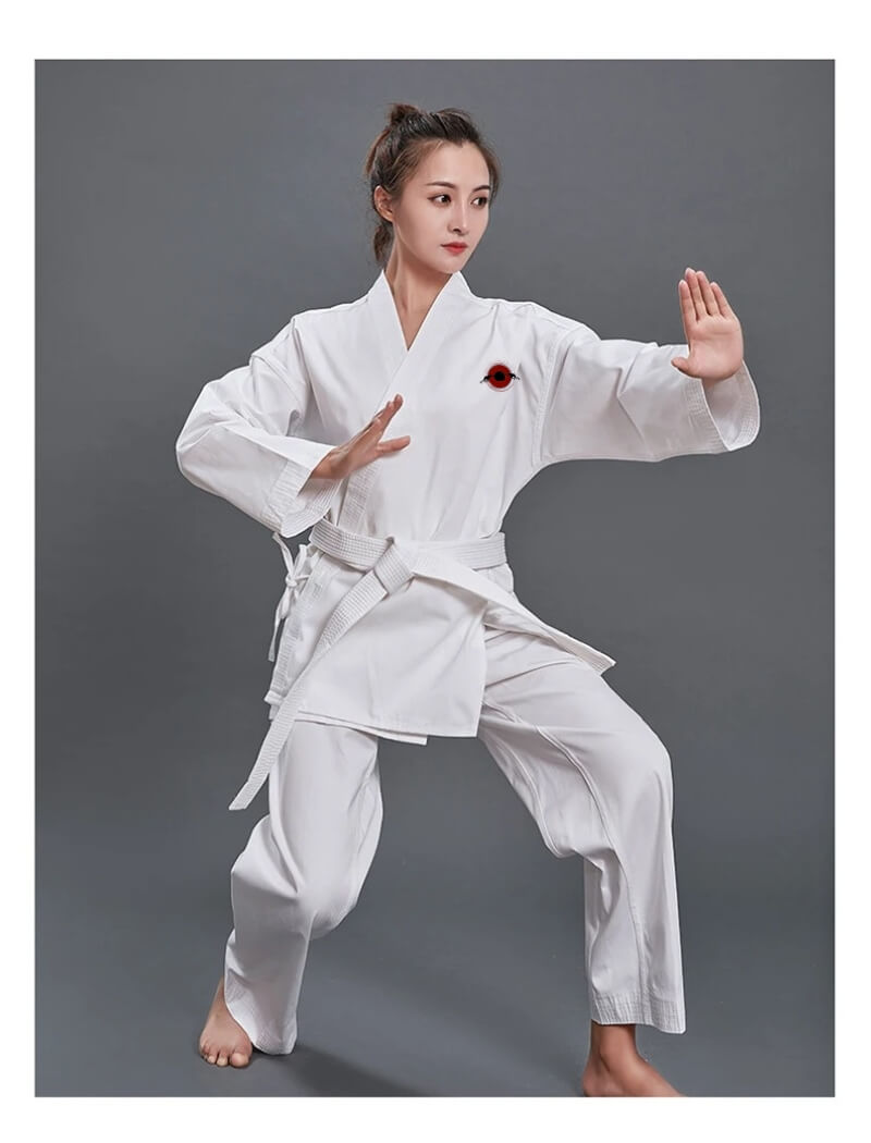 A woman wearing a14oz heavy karate gi and white karate belt sold by 100 Spartans