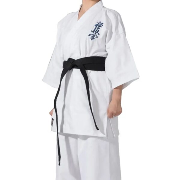 A woman wearing a 12oz white Kyokushin Karate Uniform sold on 100 Spartans